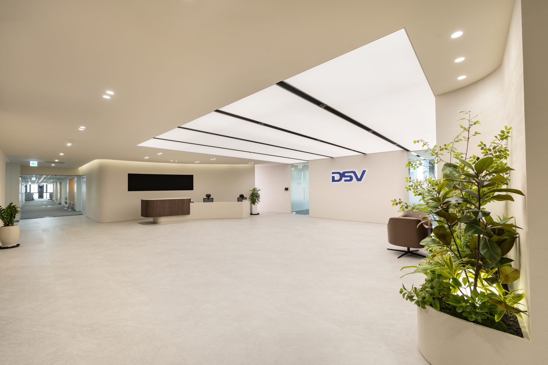 DSV 디에스브이에어앤씨 DSV Air & Sea 오피스 인테리어 - 시드나인 SIDnine 시공, 라이트 패널 천장과 플랜테리어, 리셉션이 함께 구성된 넓은 로비 공간